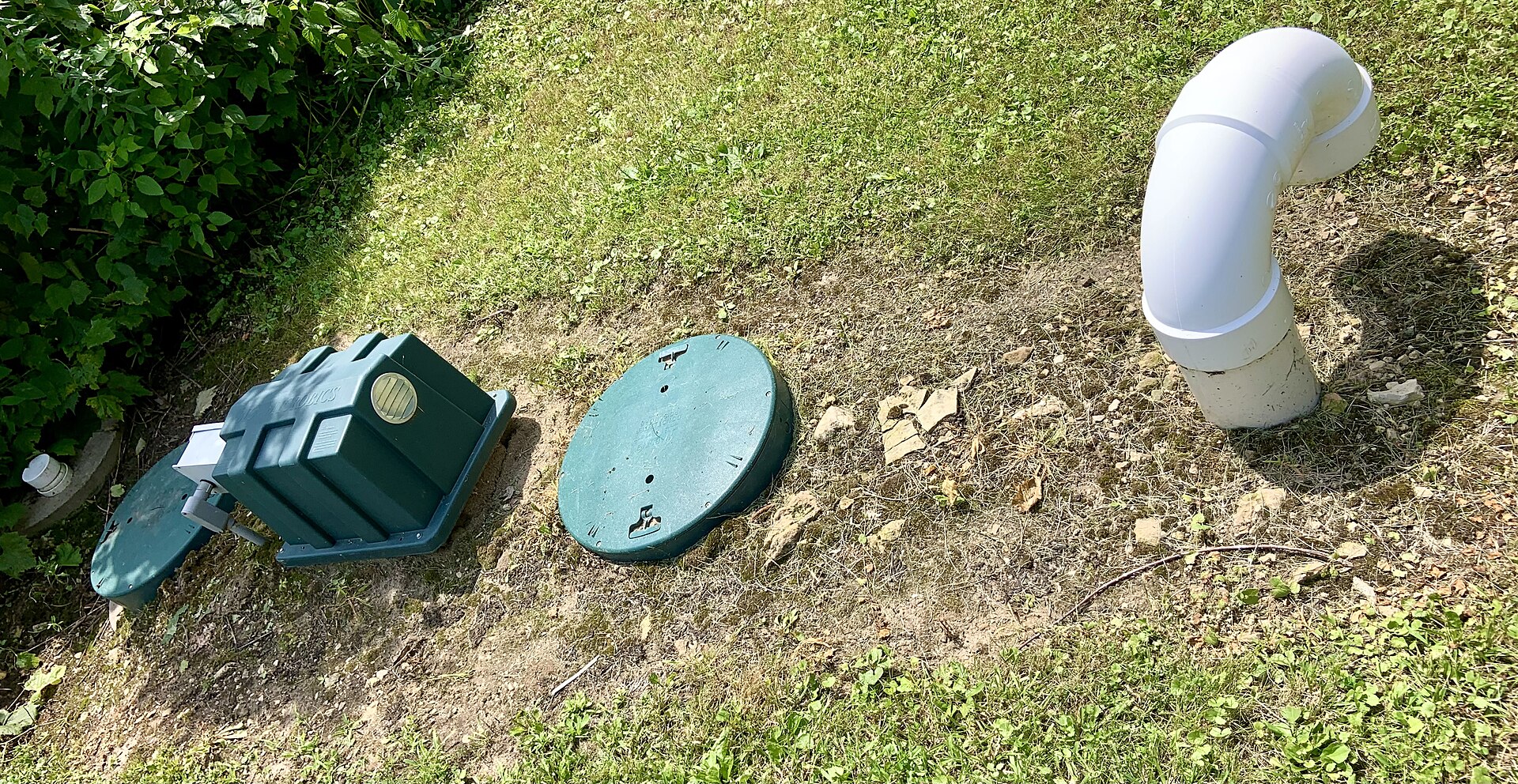 Septic tank access lid in a garden